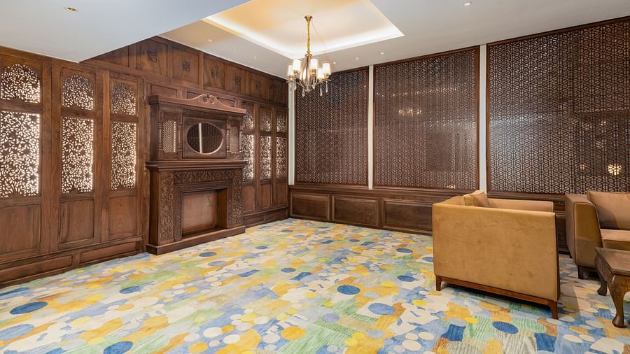an image of our sitting lounge featuring carved wood panels and carpeted floors - Sarovar Premiere, Srinagar